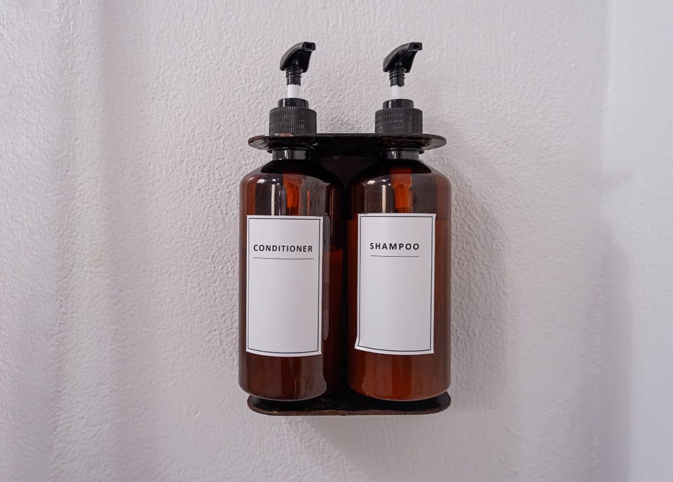 Shower wall mounted dispenser pumps of conditioner and shampoo